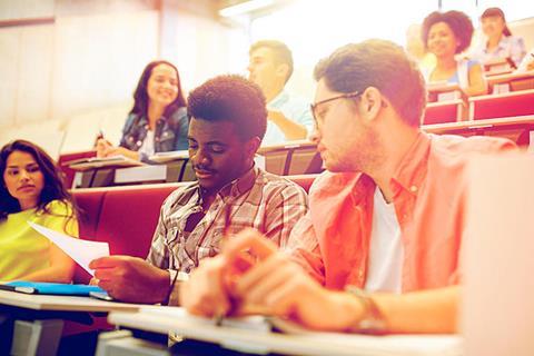 Students talking at their desks in a lecture hall